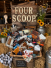 Display of various items with 'Four Scoop' sign in a rustic setting