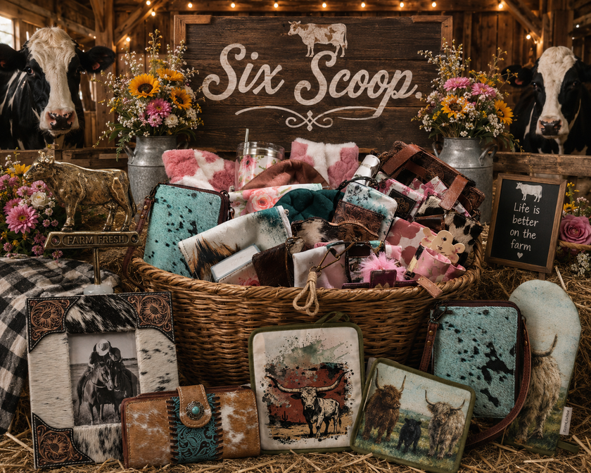 Basket of cow-themed products with 'Six Scoop' sign in a barn setting