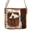 Brown and beige handbag with floral pattern and cowhide leather flap on a white background