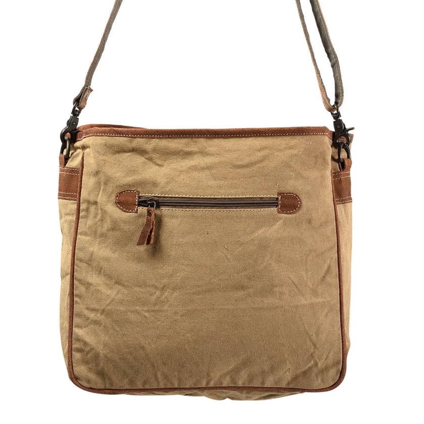 Brown leather and canvas handbag with a shoulder strap on a white background