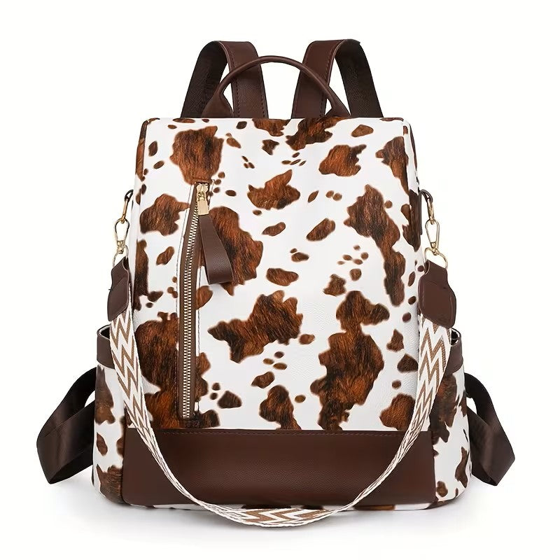 A brown and white cow print backpack