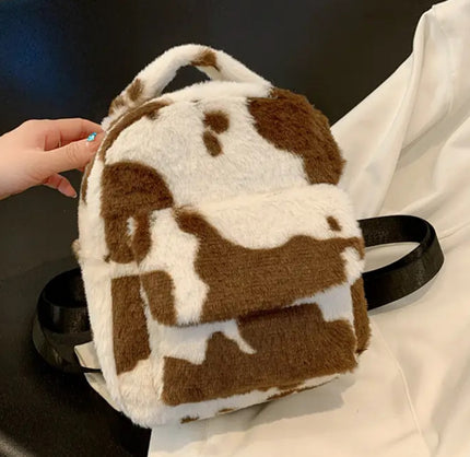 A brown and white plush backpack