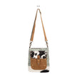 Crossbody bag with cowhide pattern on a white background