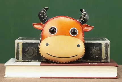 an orange coin purse shaped as a steer face