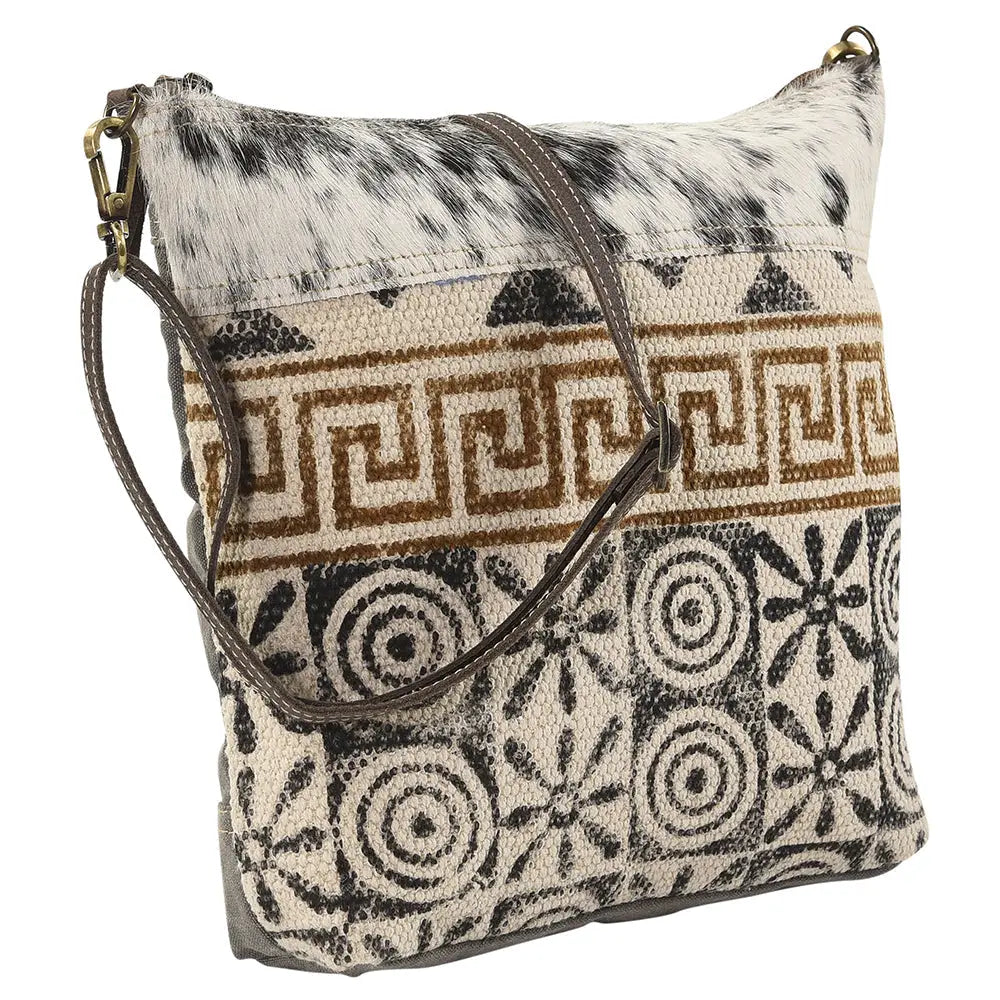 Patterned handbag with cowhide texture on a white background