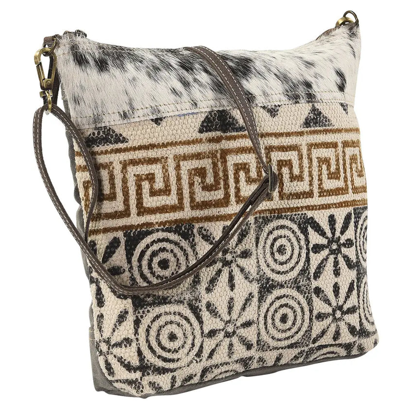 Patterned handbag with cowhide texture on a white background