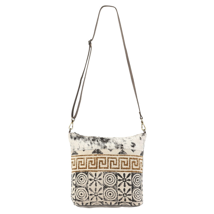Patterned shoulder bag with a strap on a white background